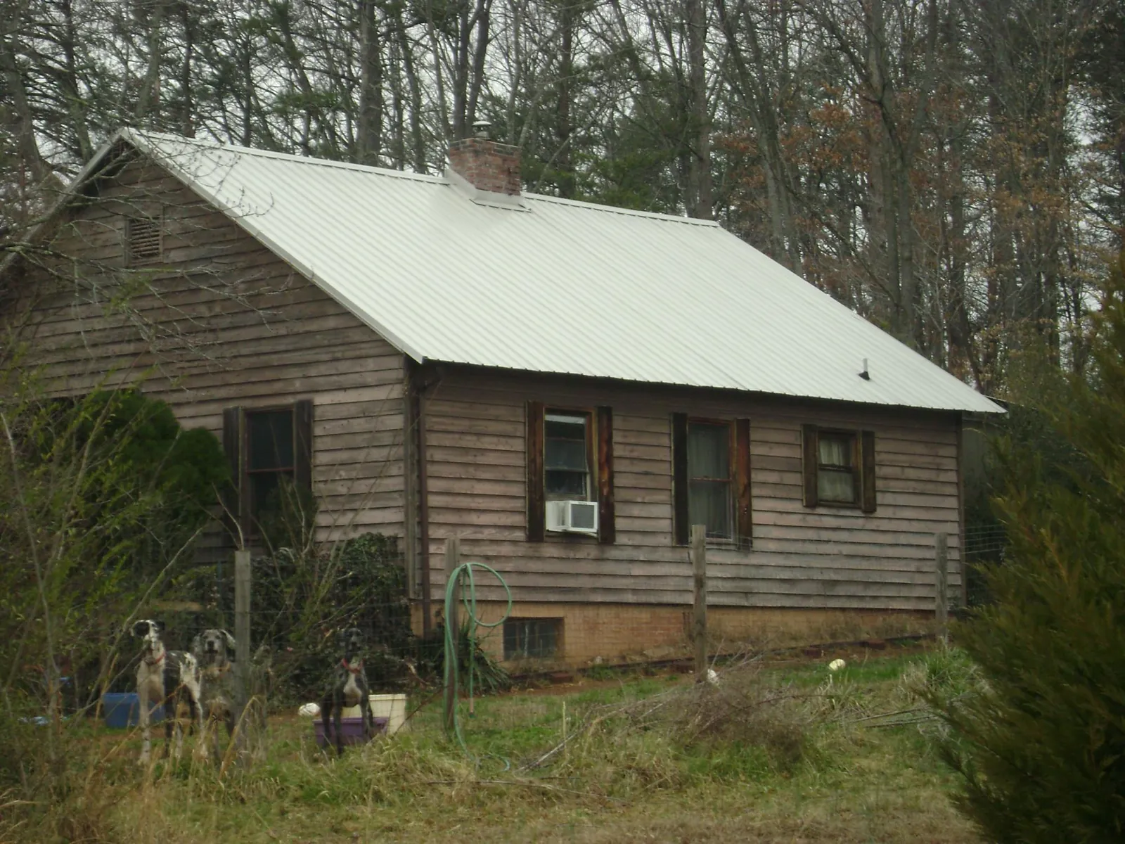 White metal roof on an old wood sided farmhouse, from a Metal Roof Installation job in Hinckley